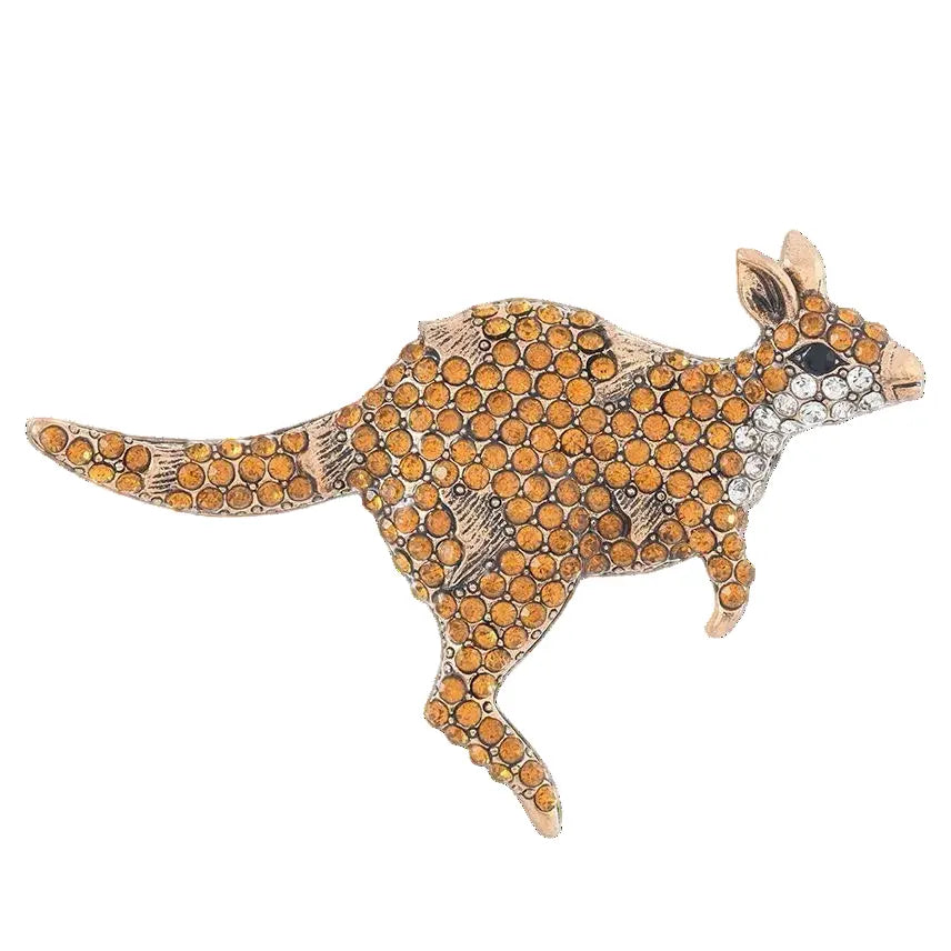 Kangaroo-shaped brooch with orange gemstones on a white background