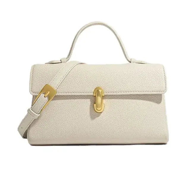 Beige handbag with gold accents on a white background