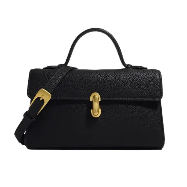 Black handbag with gold accents on a white background