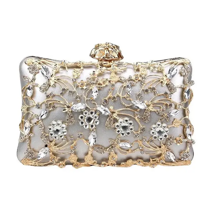 Decorative clutch bag with gold and silver embellishments on a white background