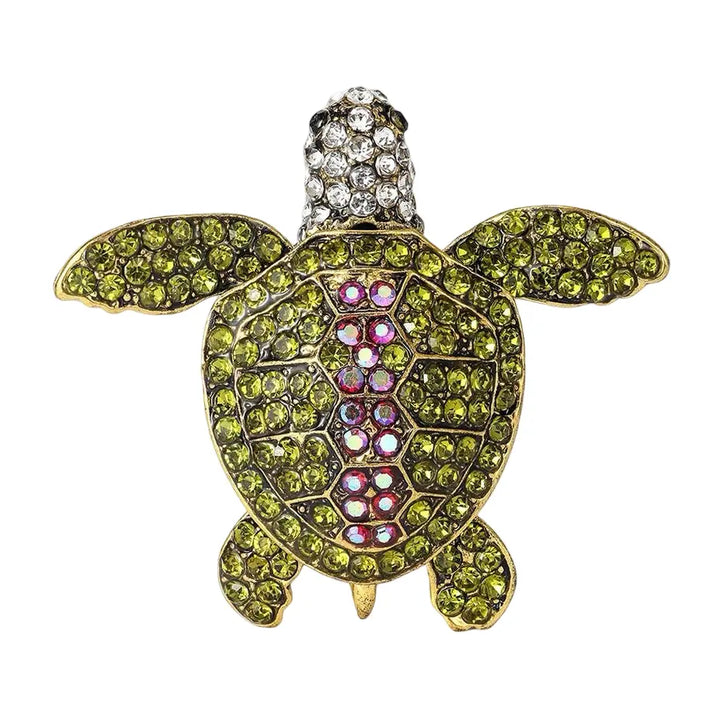 Decorative turtle figurine with gemstones on a white background