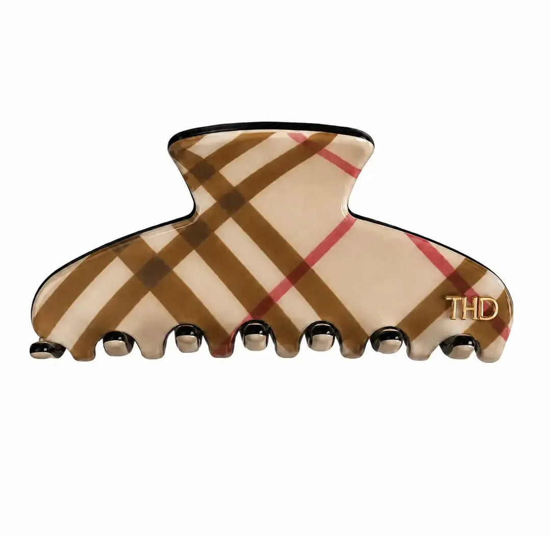 A Medium size hair claw clip in a beige and brown plaid pattern with thin red stripes, black trim, and a small gold THD logo on the lower right, shown on a plain white background.
