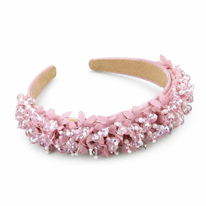 Pink headband with floral and bead details on a white background